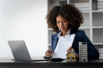 African American realtor working at desk, Housing estate, Vacancy, Prime location, Description of...