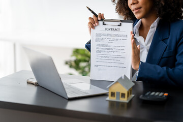 African American realtor working at desk, Housing estate, Vacancy, Prime location, Description of...