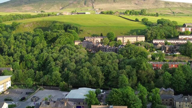 flying across todmorden town centre whilst panning up and zooming out and flying forwards 
multi axis shot of a beautiful rural town in england 