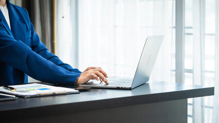 Young chinese business woman doing bookkeeping analyst audit working papers, public offering, cash...