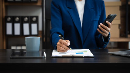 Young chinese business woman doing bookkeeping analyst audit working papers, public offering, cash...