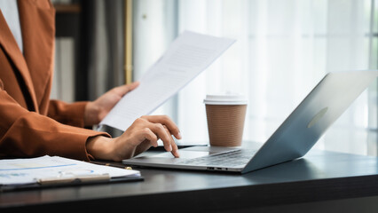 Young chinese business woman doing bookkeeping analyst audit working papers, public offering, cash...