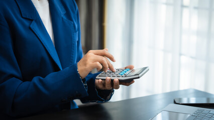 Young chinese business woman doing bookkeeping analyst audit working papers, public offering, cash budget, accrued dividend, note payable, actual cost, aging schedule, intangible fixed asset