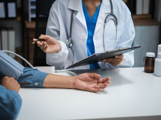 Mature chinese woman in consultation with a doctor with abdominal pain. depression.