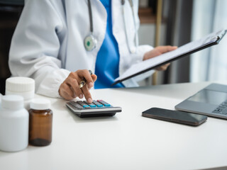 Mature chinese woman in consultation with a doctor with abdominal pain. depression.
