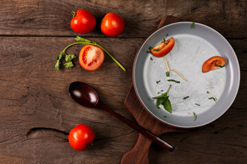The empty plate of fried spaghetti or fried noodles Tomato sauce and prawns, tomatoes, and basil on wooden table background, top view