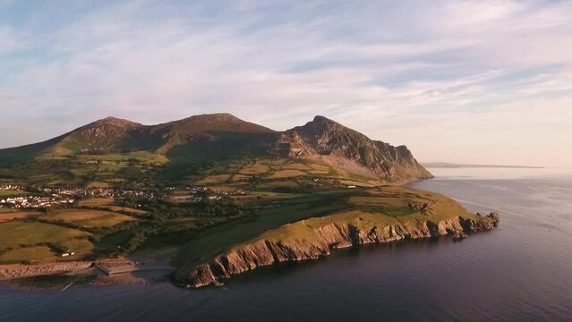 Aerial approach to Mountain range Yr Eifl at Trefor with blue skies on a summers day across the Irish Sea on the Llyn Peninsula in North Wales