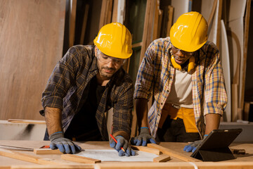 engineer wooden home builder working together consulting with plan design to build or renovate with...