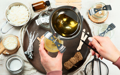 Set for homemade natural eco soy wax candles, Woman making decorative aroma candle at table.