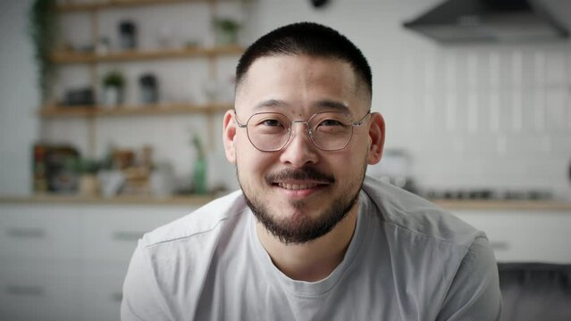 Asian Man Portrait. 30s male smiling looking at camera.