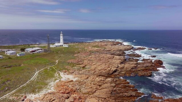 South Africa Lighthouse Cape St Francis summer Garden Route JBAY aerial drone cinematic drive from Still Bay George stunning beautiful late afternoon sunny rugged coast waves seagull birds circling