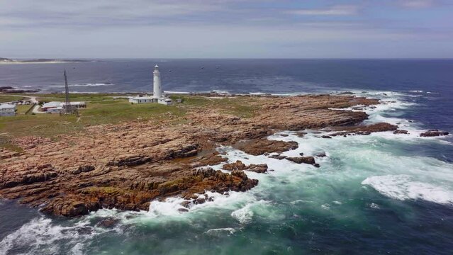 South Africa Lighthouse Cape St Francis summer Garden Route JBAY aerial drone cinematic drive from Still Bay George stunning beautiful late afternoon sunny rugged coast waves seagull birds circling