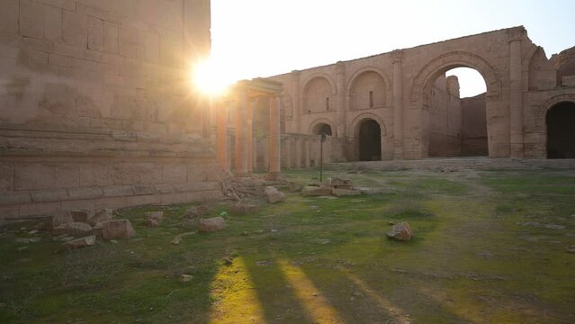 Building ruins of Hatra with shining sun behind, Iraq