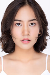 Close up face of young Asian girl with natural look make up on white background. Facial cosmetic and skin care concept.
