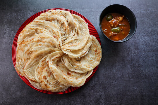 Kerala parathas / porotta / roti / parotta / barotta/ naan layered flatbread made from maida or whole wheat flour. Eat with spicy Asian chicken or beef or egg curry gravy. breakfast dish. Indian food.