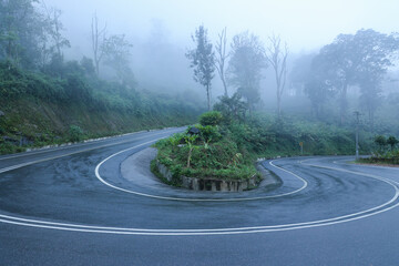 Long winding mountain road leading through rural countryside in Munnar Kerala India. Mountain...