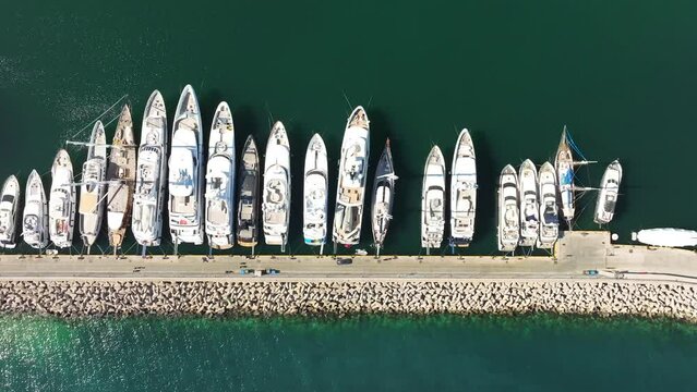 Aerial topdown view over Yachts anchored in the pier of Marina Zeas, Greece