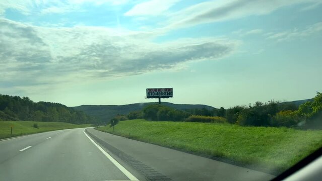 Driving and passing a road sign for McGraw, New York