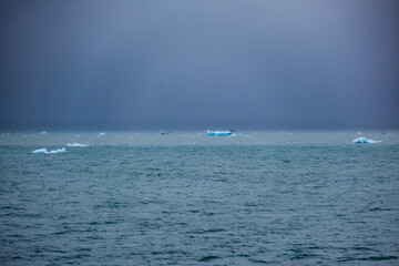 Cruise to Hubbard Glacier Bay in Alaska with floating ice bergs and drift ice floes on ocean water...