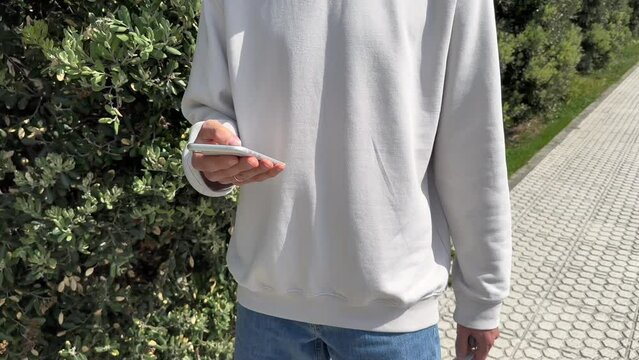 Close up view of male hands using smartphone scrolling, browsing, surfing internet, social media browsing slow motion