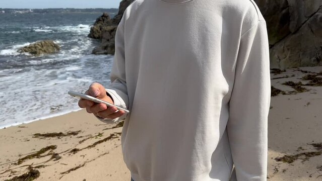 Close up view of male hands using smartphone scrolling, browsing, surfing internet, social media browsing slow motion