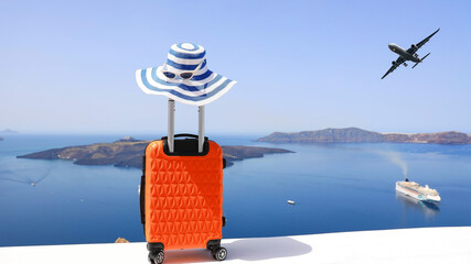 The travel concept with Orange luggage and hat as landscape view of Oia town in Santorini island in...