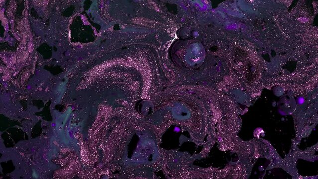 Abstract marble liquid glitter paint. Space concept. Dark and violet inks in oil