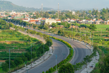 Rural landscape in Vietnam with boulevard road.  Chop from above. - obrazy, fototapety, plakaty