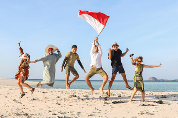 Group of people jumping together on the beach for celebrating Indonesia Independence day