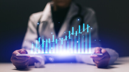 Close up of female doctor holding tablet with glowing forex chart on screen