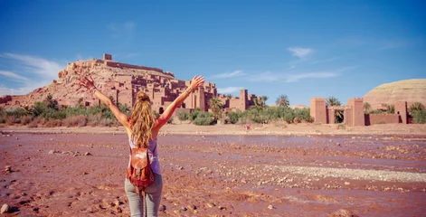 Papier Peint photo autocollant Maroc Happy woman tourist enjoying view of Ait Ben Haddou Kasbah in Morocco