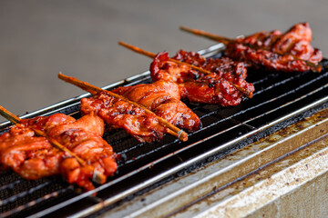 Grilled chicken skewered on a gas stove