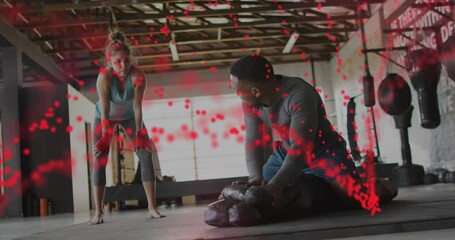 Animation of dna strand and data processing over diverse man and woman exercising in boxing gym - Powered by Adobe