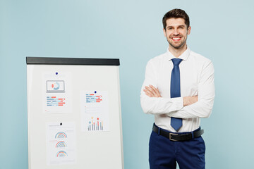 Young smiling fun employee IT business man corporate lawyer wear classic formal shirt tie work in office show documents on marker board isolated on plain pastel light blue background studio portrait.