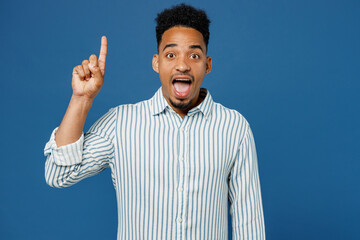 Young insighted man of African American ethnicity he wear casual clothes shirt holding index finger up with great new idea isolated on plain dark royal navy blue background studio. Lifestyle concept.