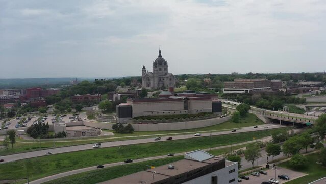 Low super wide aerial shot flying over Saint Paul towards the immense Cathedral of Saint Paul in Minnesota. 4K