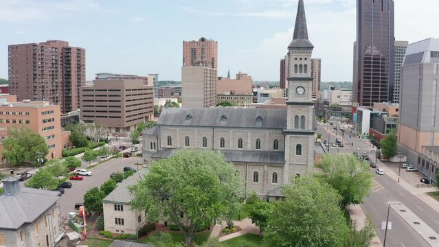 Rising and panning aerial shot of a historic Catholic church in Saint Paul, Minnesota. 4K