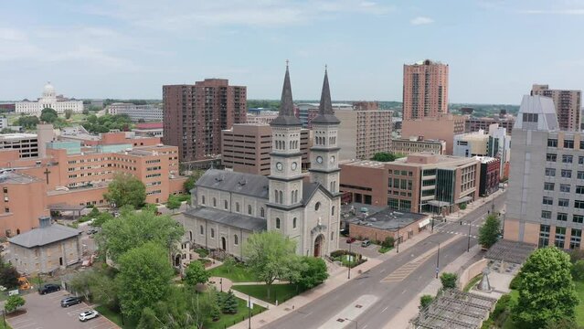 Descending and panning aerial shot of a historic Catholic church in Saint Paul, Minnesota. 4K