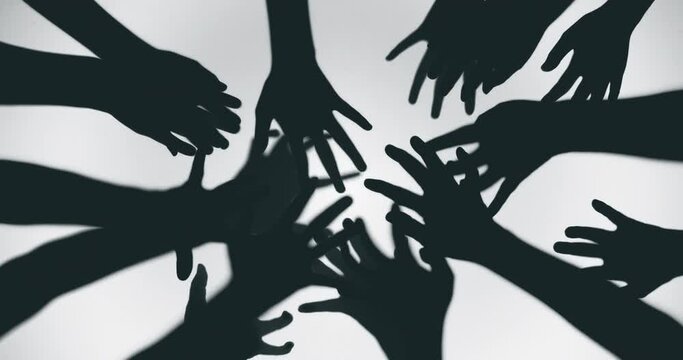 Shadow of a zombie hand on white background in slow motion
