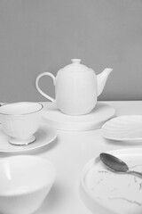 full white tableware, white glasses, white teapot, white plates