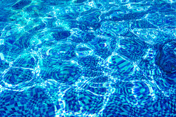 ripples on the water in a pool with a mosaic bottom.
