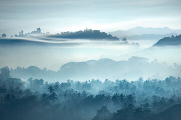 Beautiful Landscape of mountains and forest in early morning sun rays and fog near village Ngapali, Myanmar. - 615703209