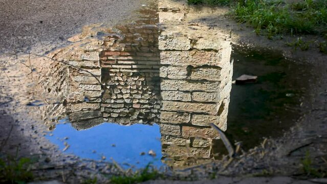 Roman ruins reflection on the rainwater pond in the ancient town of Cuicul. Djemila, Setif, Algeria
