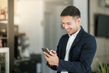 Asian business man using cell phone. Having Conversation, typing sms or presenting.