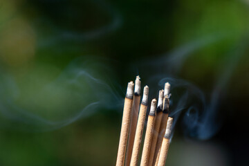 Close-up shot of burning incense with smoke. Asian beliefs