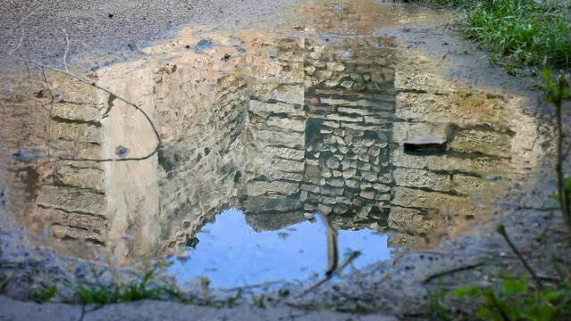 Roman ruins reflection on the rainwater pond in the ancient town of Cuicul. Djemila, Setif, Algeria