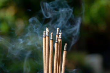 Smoke of burning incense sticks in temple, selective focus.