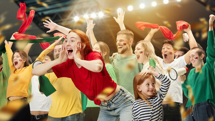 Fototapeta premium Girl going on mathc with her little sister. Young people, football fans attending match to watch game and cheer up favourite sport team. Sport, leisure time, emotions, hobby and entertainment