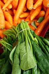 organic and fresh spinach and carrots at the market counter
