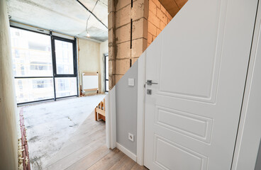 Old apartment with brick walls and new renovated flat doors, living room and elegant interior...